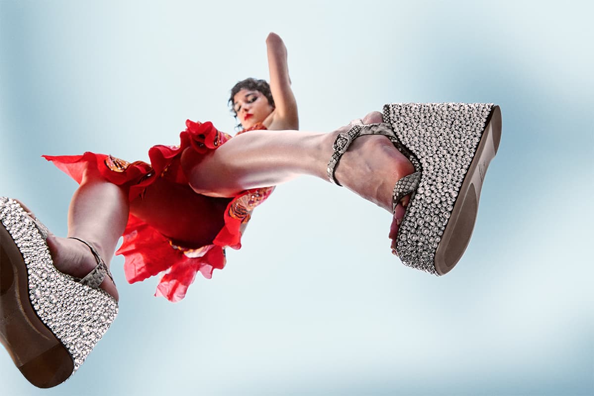Model jumping with Haus Of Honey Croco Crystal Sandals on shot from below