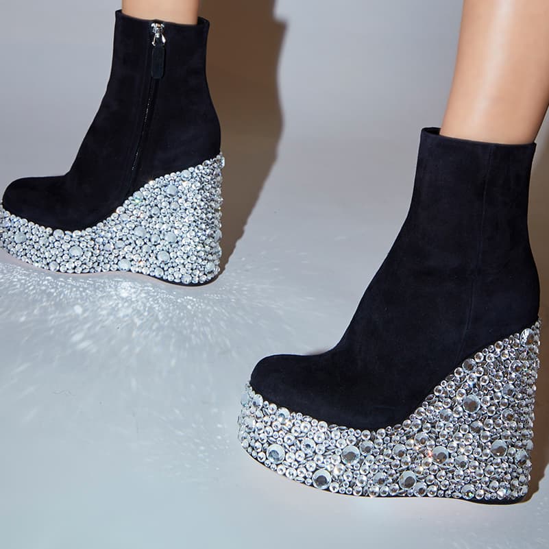 Close-up of Croco Crystal ankle boot with wedge heel in black being worn