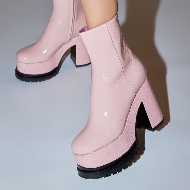 Close-up Lacquer Doll ankle boot pink patent being worn