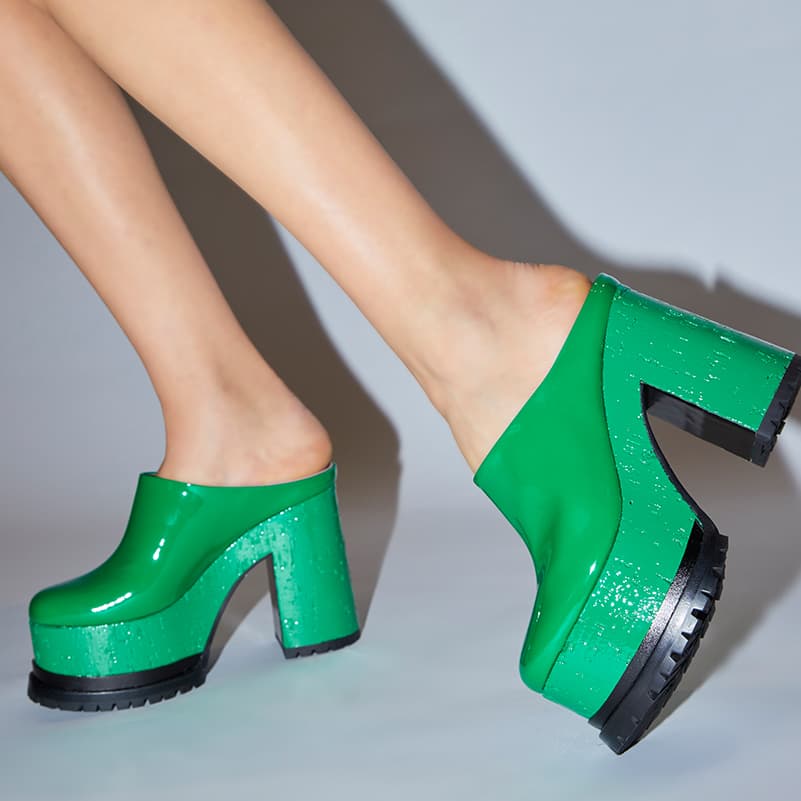 Close-up of Lacquer Doll sabot green patent leather being worn